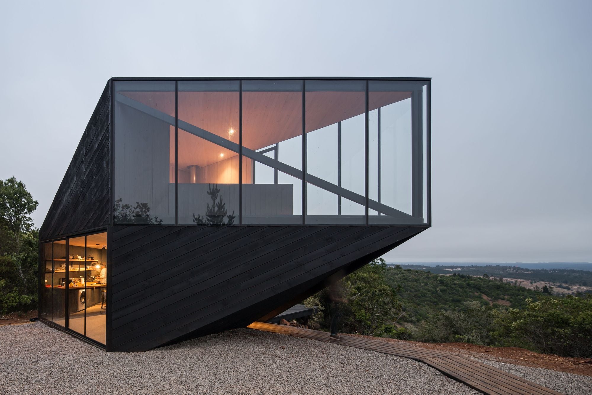 Black Timber-Clad Angular Holiday Cabin Points Toward Chilean Coast