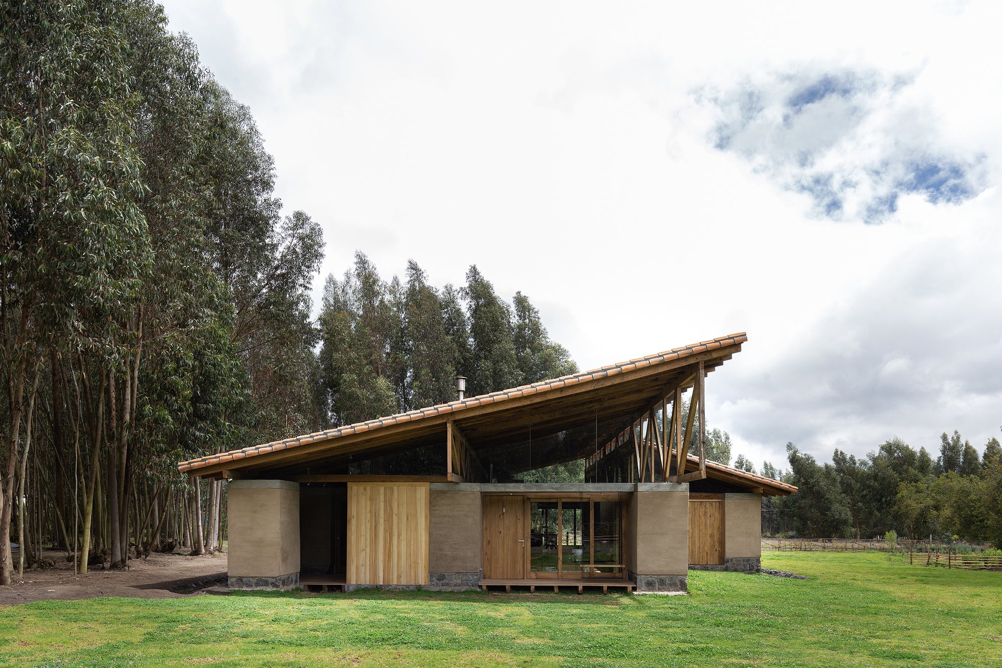 Rama Estudio's Casa Lasso In Rural Ecuador Has Angled Roof Tops And Rammed-Earth Walls