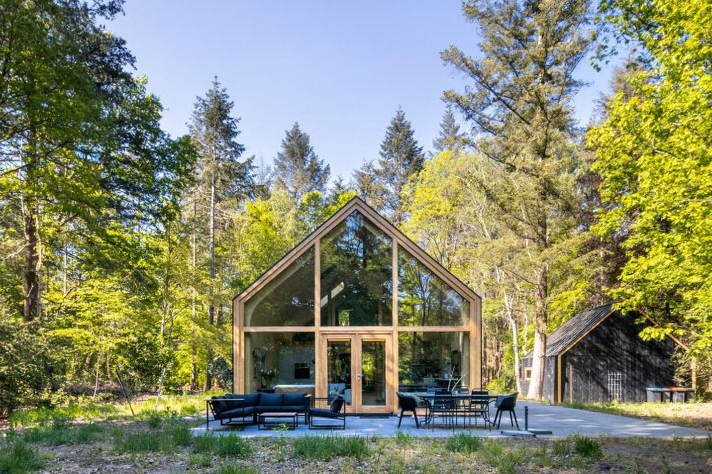 Woonpioneers Conceals A Prefabricated Indigo Cabin In The Woodland